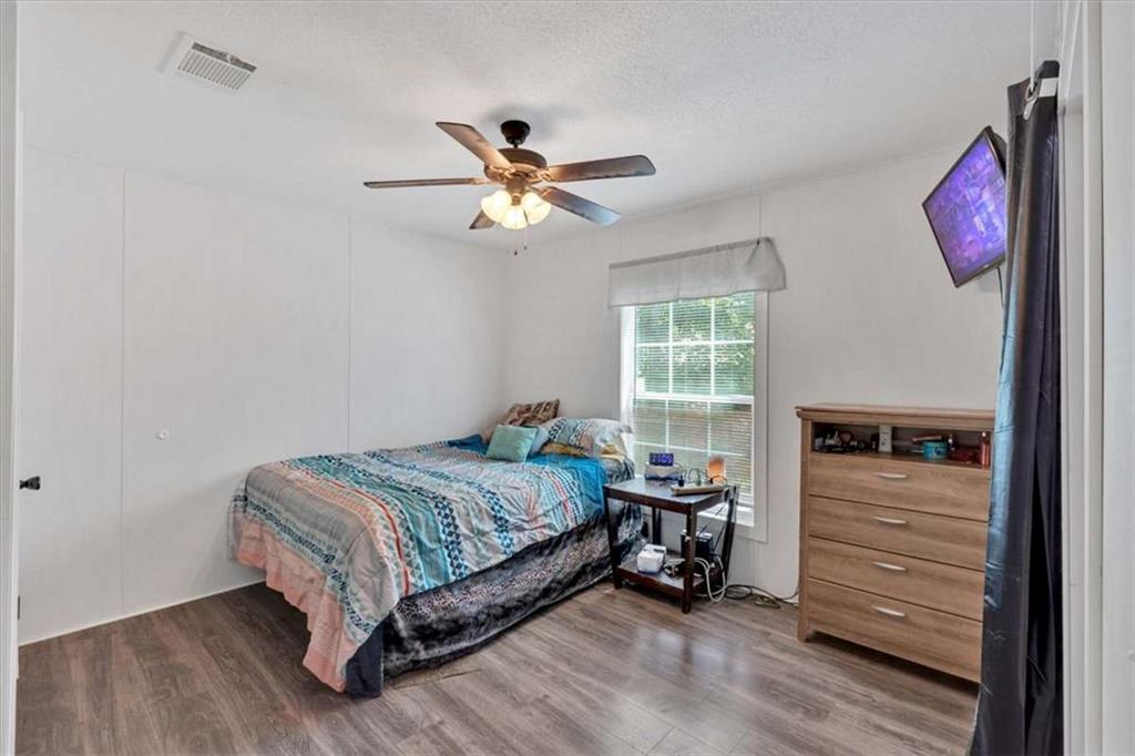 196 Whitestone Drive Talking Rock, GA 30175 - Photo 26 of 62 a bedroom with a bed and a chandelier