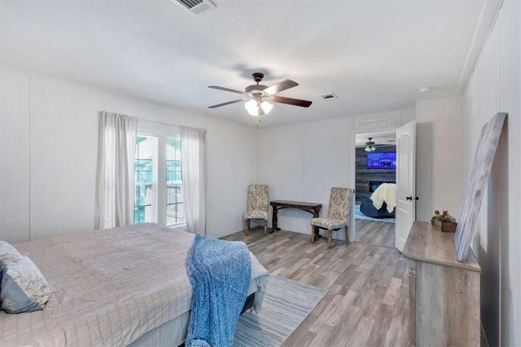 196 Whitestone Drive Talking Rock, GA 30175 - Photo 29 of 62 a bedroom with a bed and a chandelier