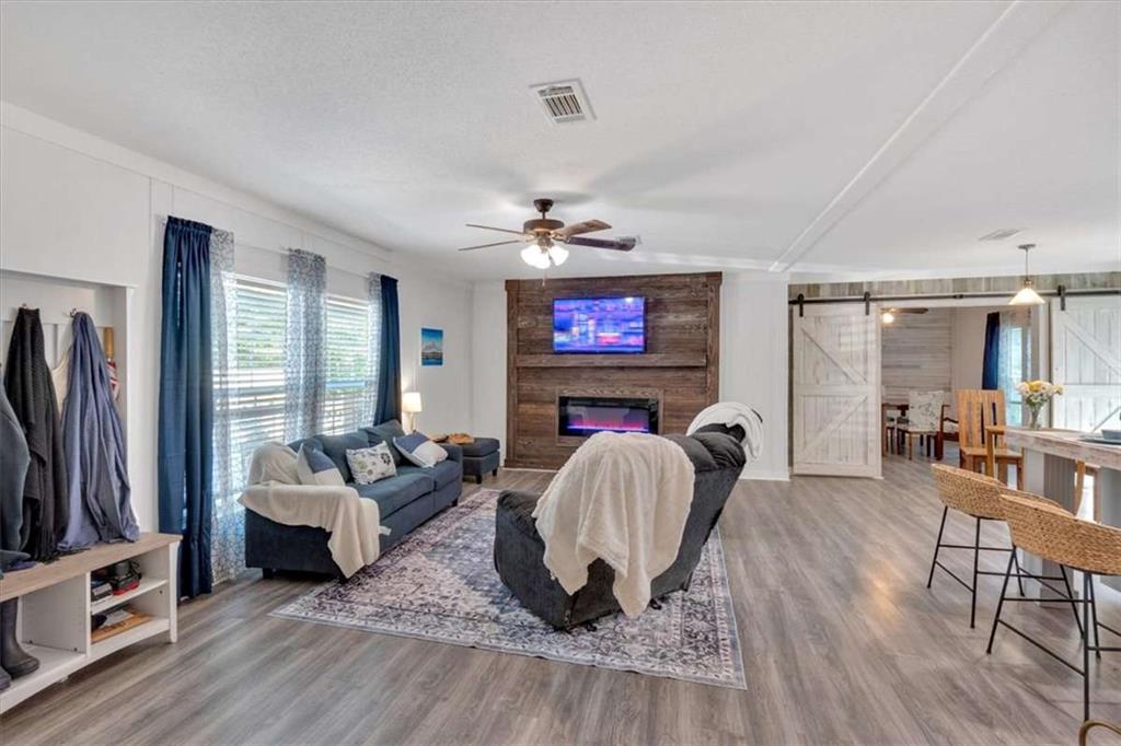 196 Whitestone Drive Talking Rock, GA 30175 - Photo 8 of 62 a living room with furniture a flat screen tv and a fireplace