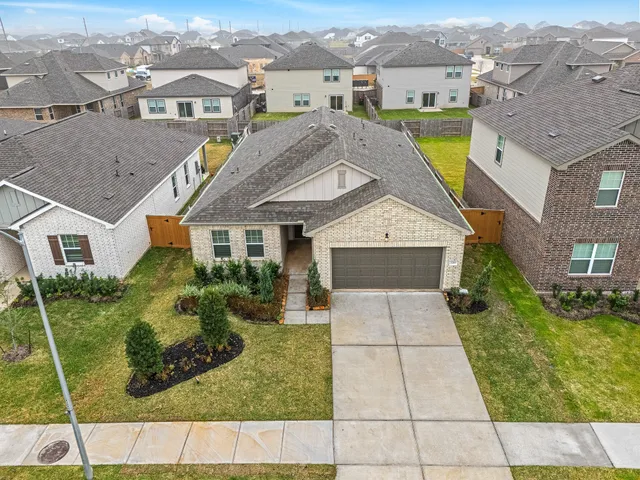 an aerial view of a house with a yard