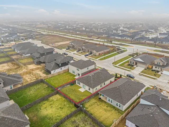 an aerial view of residential houses with outdoor space