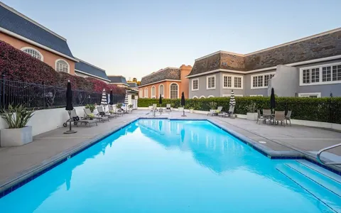 a swimming pool view with a outdoor seating