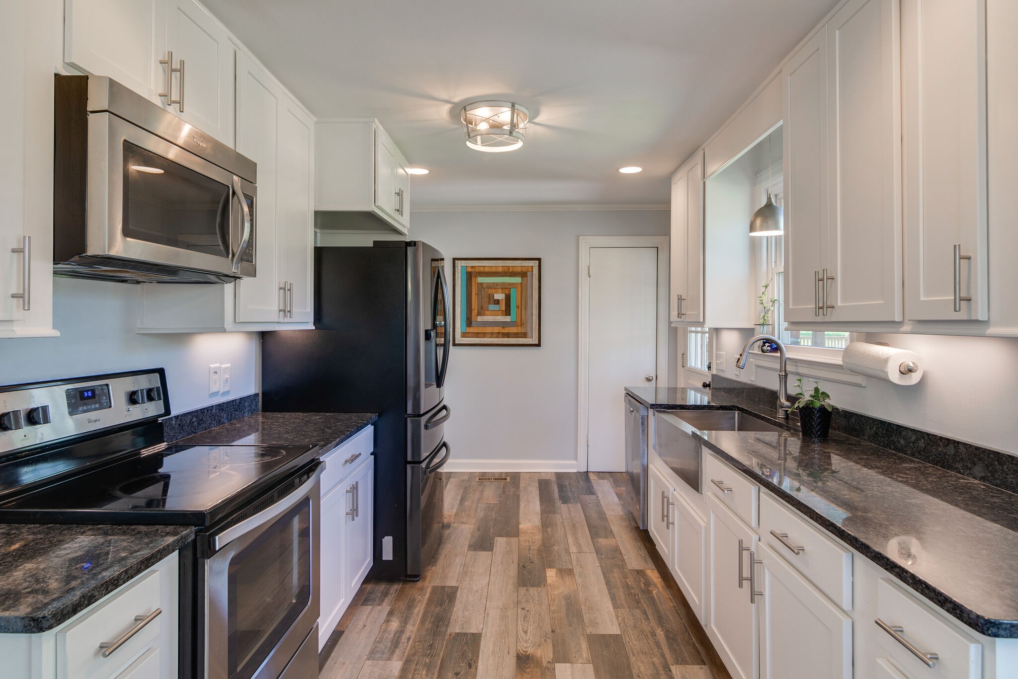1213 Neelys Bend Road Madison, TN 37115 - Photo 12 of 36 a kitchen with stainless steel appliances granite countertop a stove a sink and a microwave
