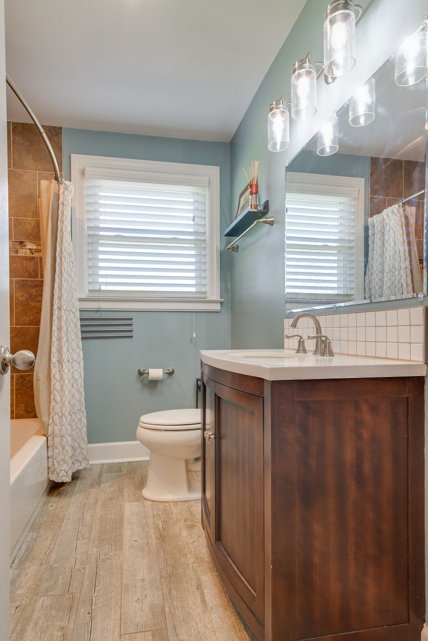 1213 Neelys Bend Road Madison, TN 37115 - Photo 18 of 36 a bathroom with a sink a toilet and a window