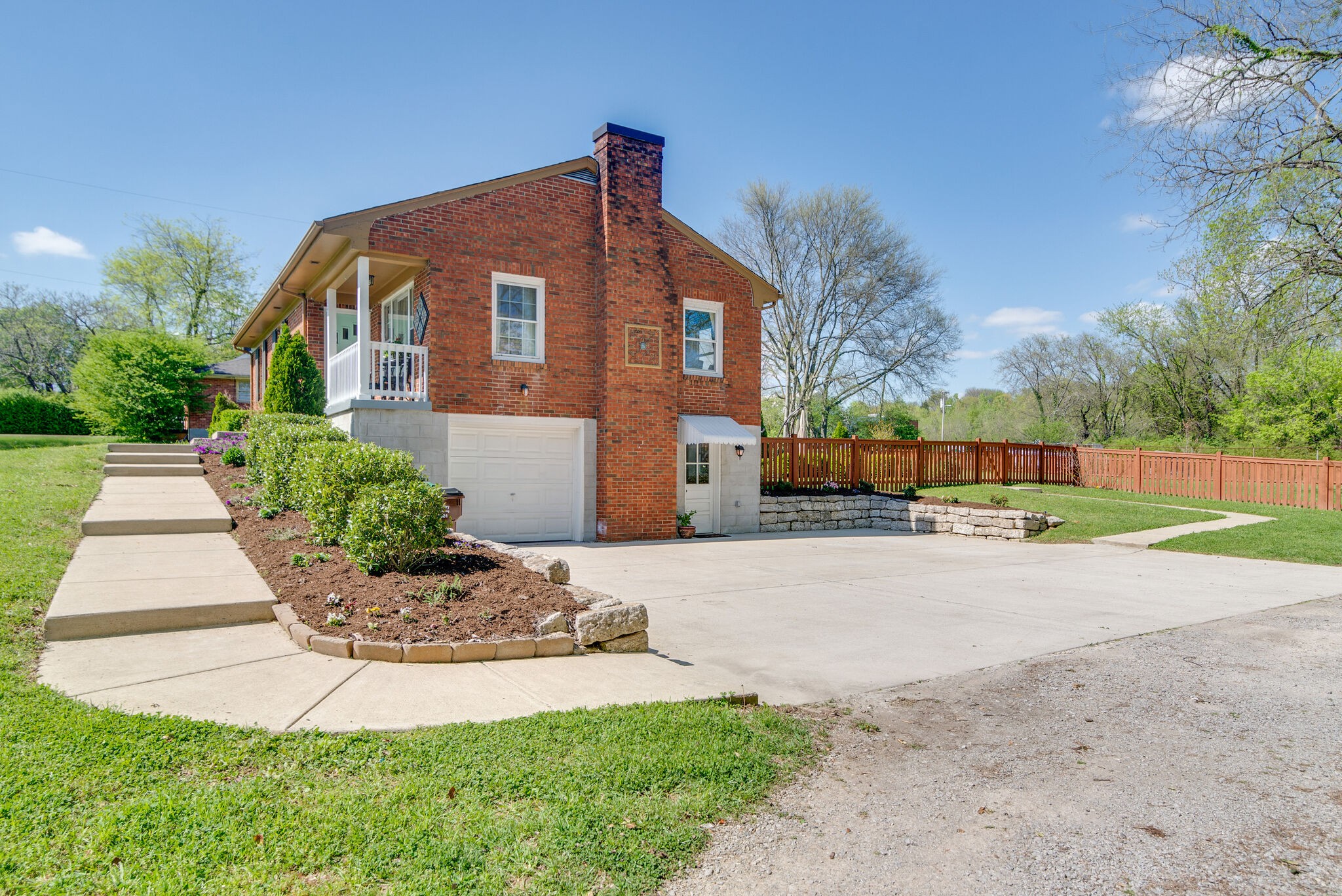 1213 Neelys Bend Road Madison, TN 37115 - Photo 4 of 36 a front view of a house with a yard and garage
