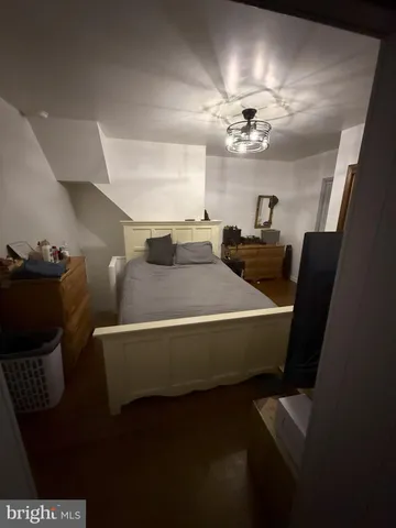 a bedroom with a bed and cabinet