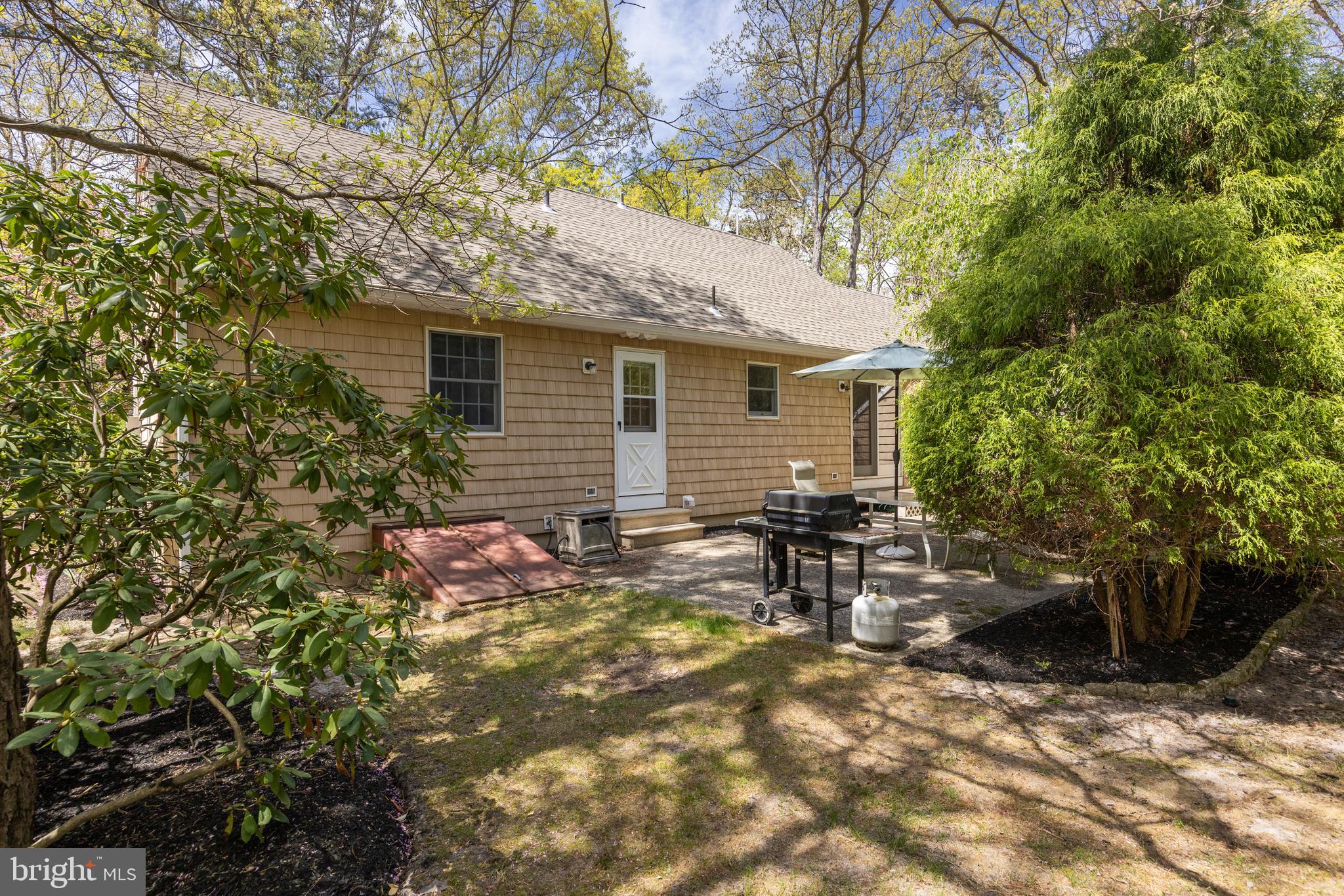 88 Oakshade Road Tabernacle, NJ 08088 - Photo 29 of 34 a view of a backyard with table and chairs and potted plants