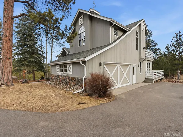 a bedroom with a bed couch and a fireplace