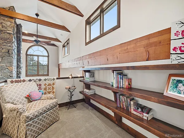 a bathroom with a granite countertop bathtub a sink and a large mirror