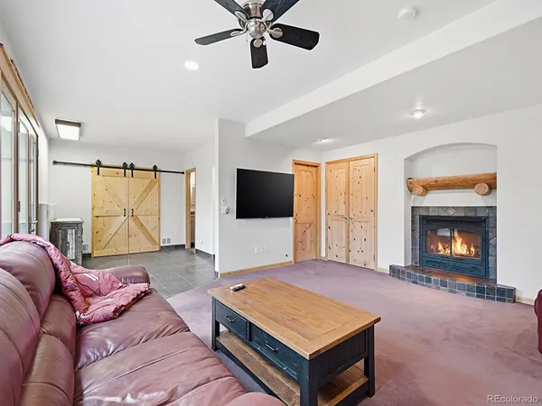 a picture of a room with a white bed and a white refrigerator