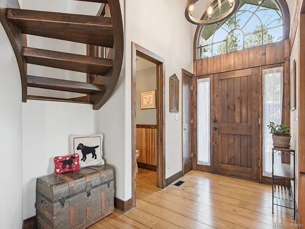 a view of an entryway with wooden floor