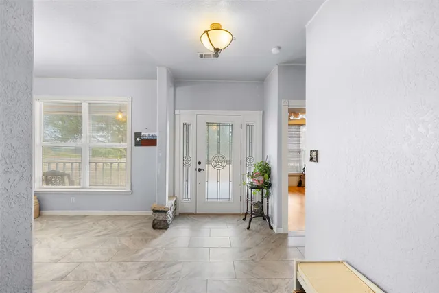 a view of an entryway with wooden floor