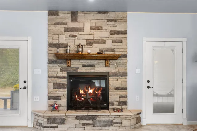 a fireplace with a vase on top of it