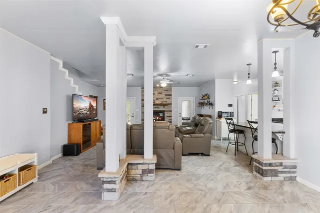 a living room with furniture and painting on the wall
