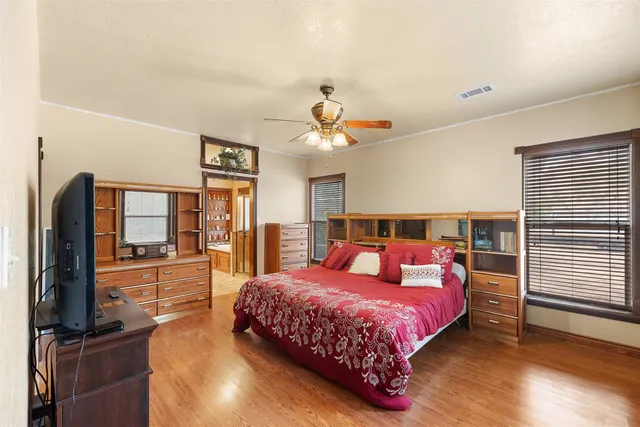 a bed room with furniture and a flat screen tv