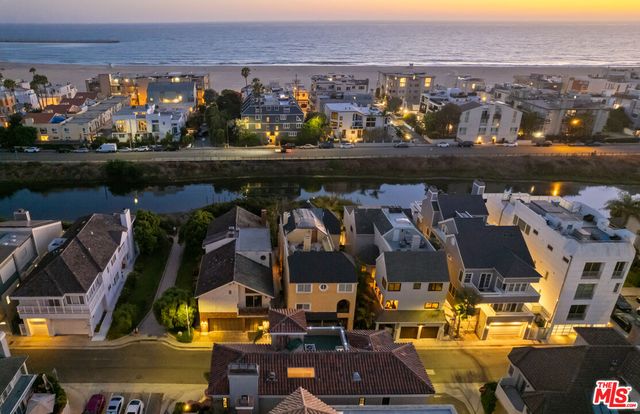 an aerial view of a residential houses with city view