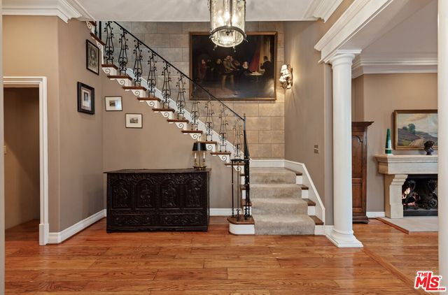 a view of entryway and hall with wooden floor