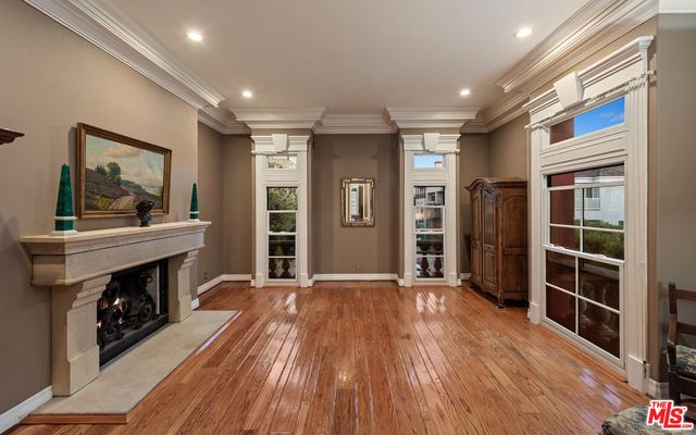 a view of an empty room with a fireplace and a window