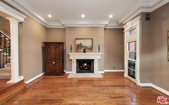 a view of an empty room with window and fire place