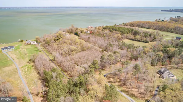 a view of a livingroom with wooden floor and furniture