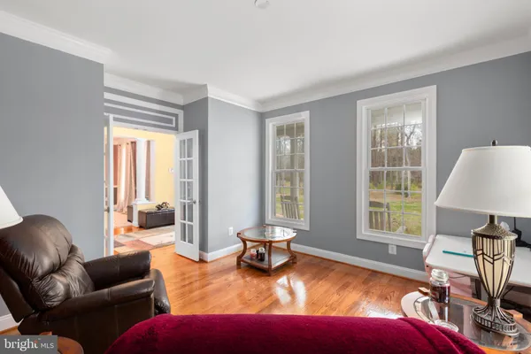 a living room with furniture a fireplace and a large window