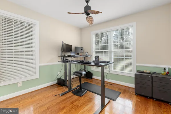 a front view of house with yard and trees in the background