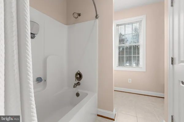 an aerial view of a house with a yard and large tree