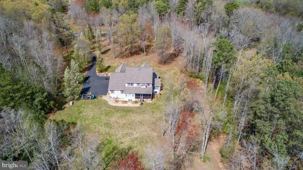 a view of a wooden house with a yard