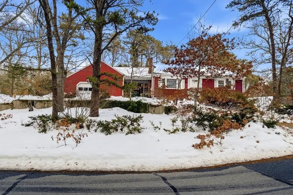 a view of a house with a snow on the road