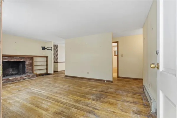 a view of an empty room with fire place