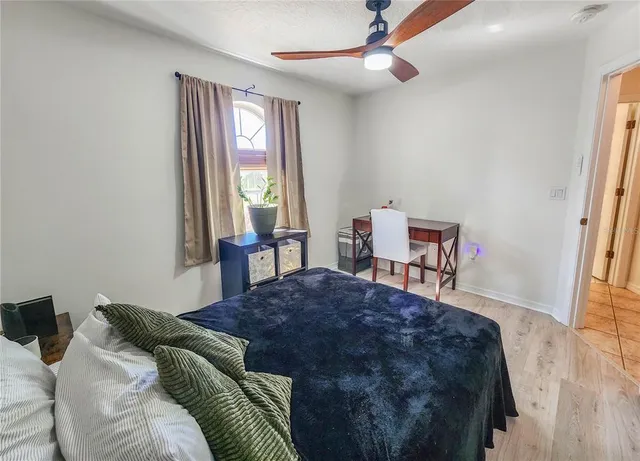 a bedroom with a bed and a chair