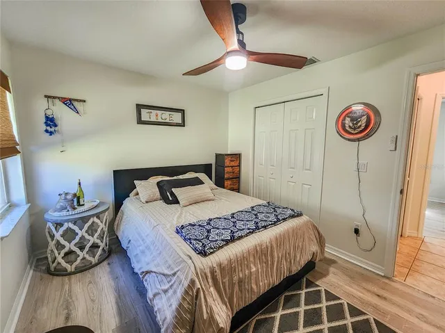 a bedroom with a bed a book shelf and a window