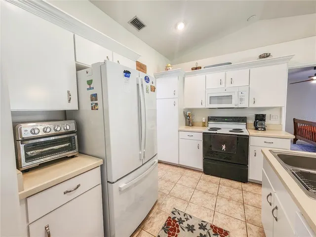 a kitchen with a stove top oven and cabinets