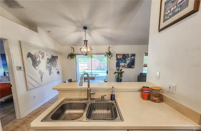 a kitchen that has a refrigerator a stove a sink and a stove