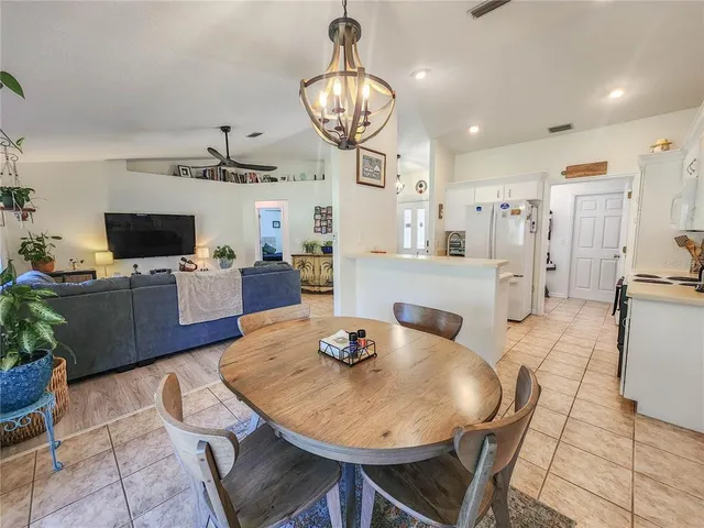 a view of a dining room with furniture wooden floor and chandelier