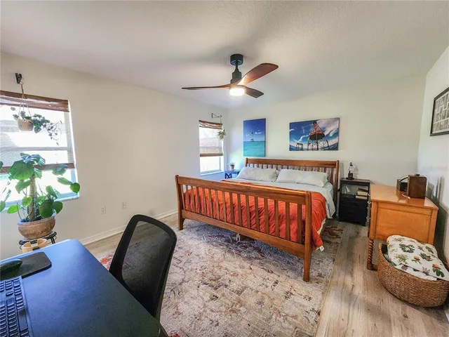a bed sitting in a bedroom next to a window