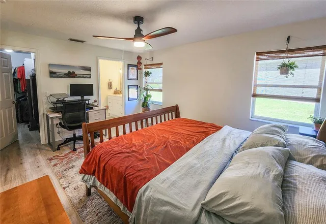 a bed room with a bed and a chandelier