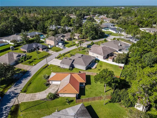 an aerial view of a house with a garden and swimming pool