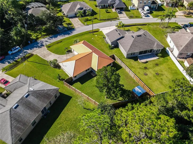 an aerial view of a house with a swimming pool
