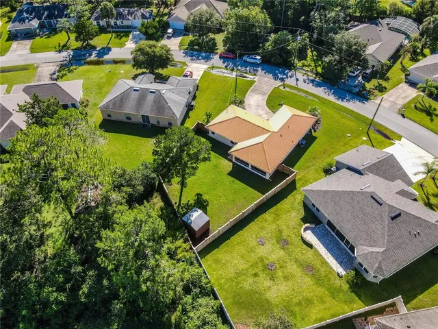 an aerial view of a house with a swimming pool yard and outdoor seating