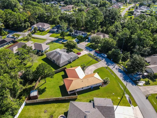 an aerial view of a house with a swimming pool