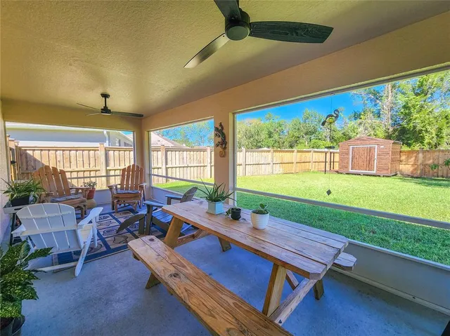 a room with pool table and windows