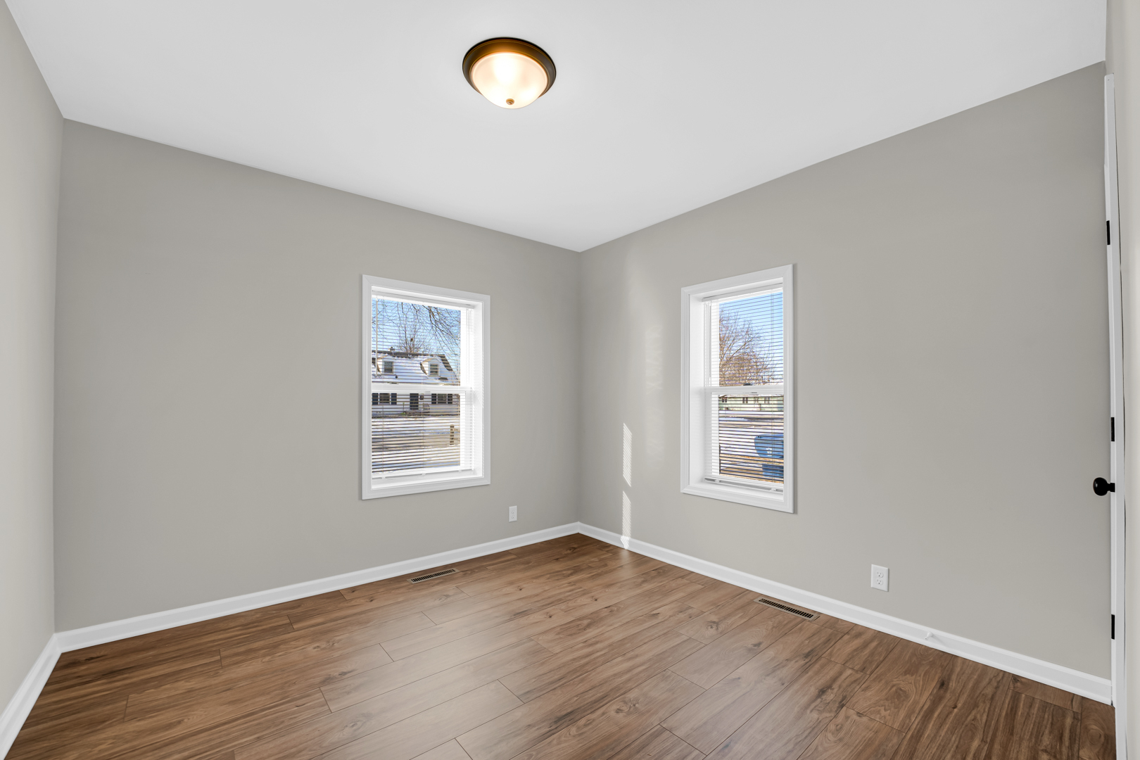 1376 Lennington Circle Northwest Kankakee, IL 60901 - Photo 9 of 16 an empty room with wooden floor and windows