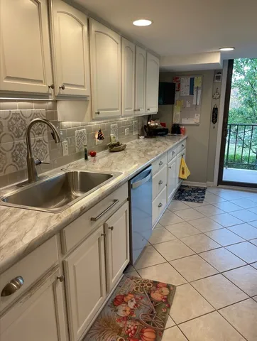 a kitchen with stainless steel appliances granite countertop a sink and a stove