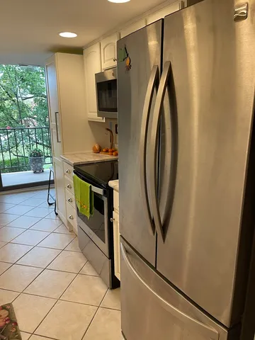 a kitchen with stainless steel appliances a stove a refrigerator and a microwave