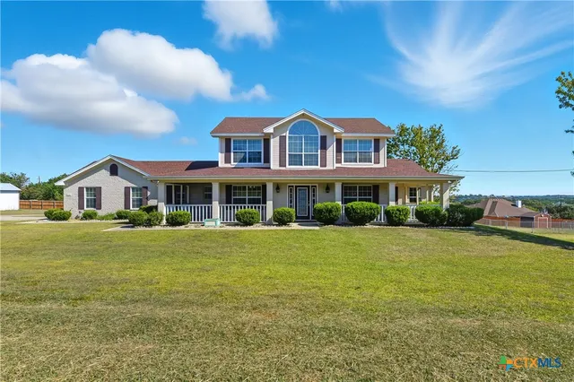 a front view of a house with a yard table and chairs