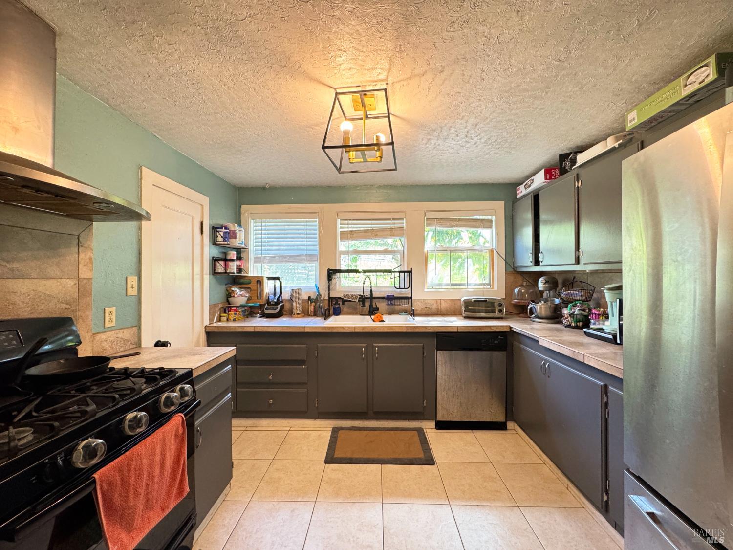 3981 Eastside Calpella Road Ukiah, CA 95482 - Photo 8 of 78 a kitchen with stainless steel appliances a stove a sink dishwasher and a refrigerator