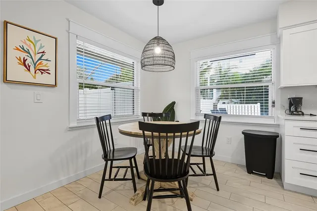 a dining room with furniture a chandelier and window