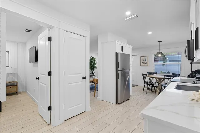 a view of kitchen with furniture and refrigerator