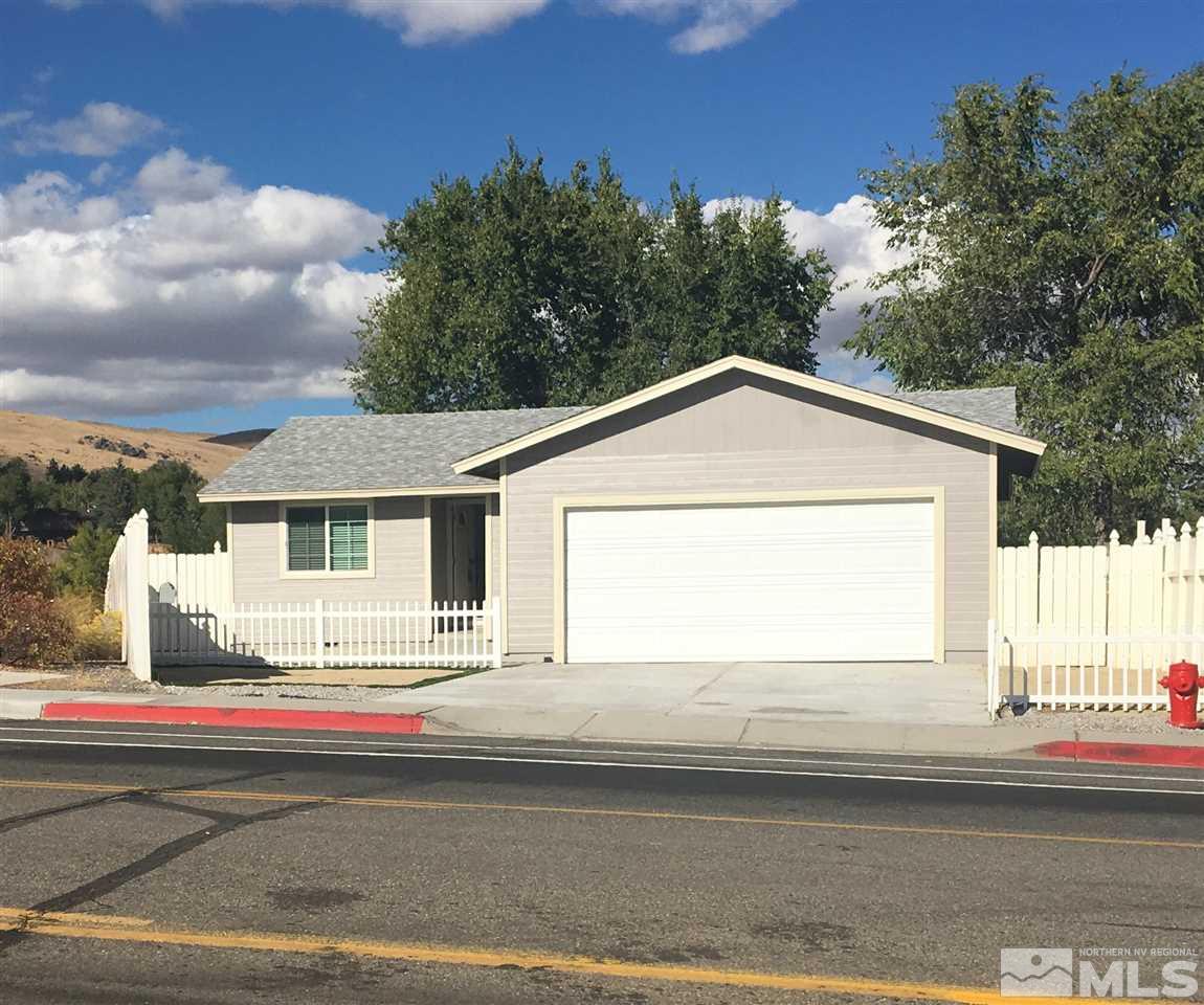 3951 West 7th Street Reno, NV 89503 - Photo 1 of 17 a front view of a house with a yard and garage